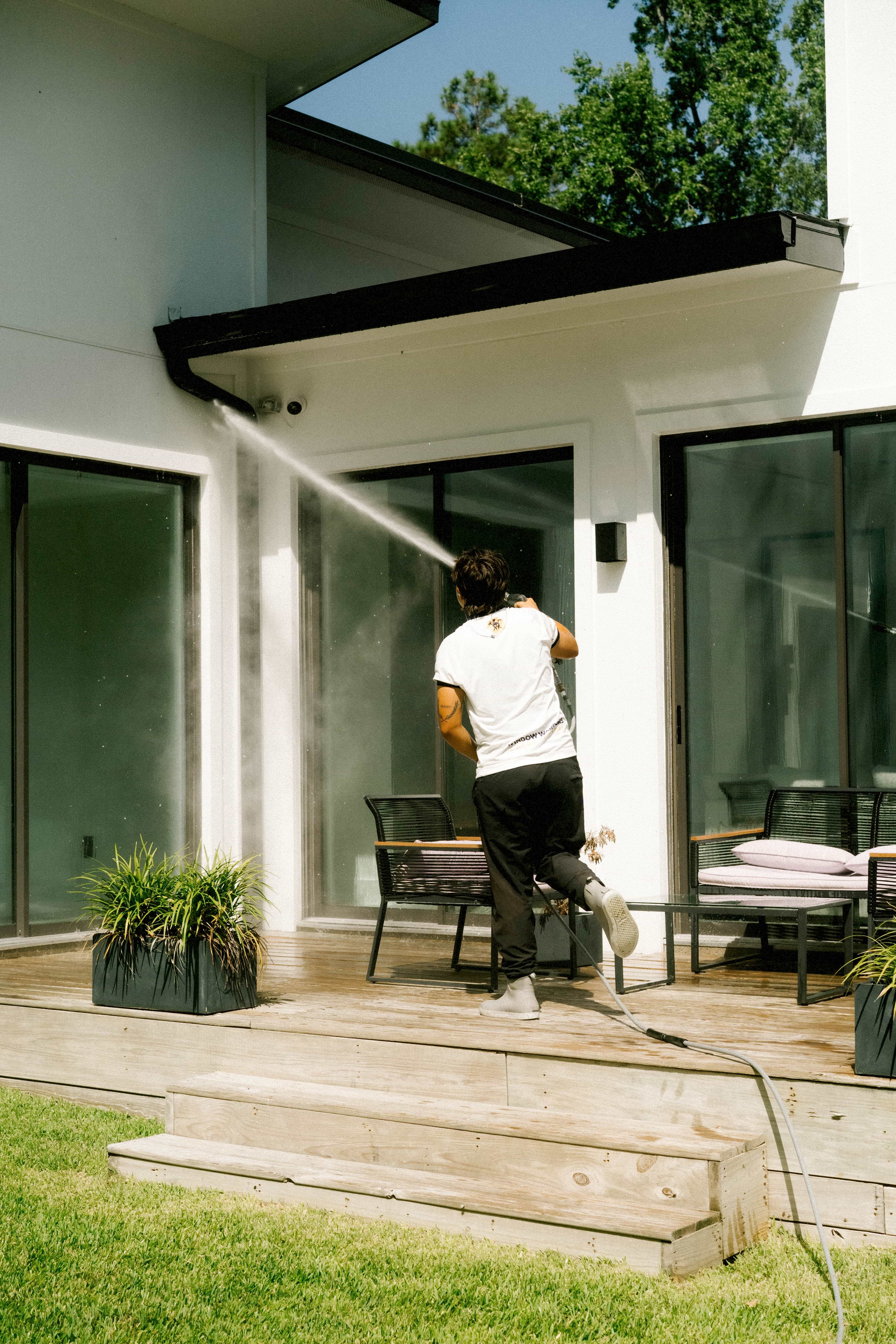 Pressure washing a covered patio and roofline
