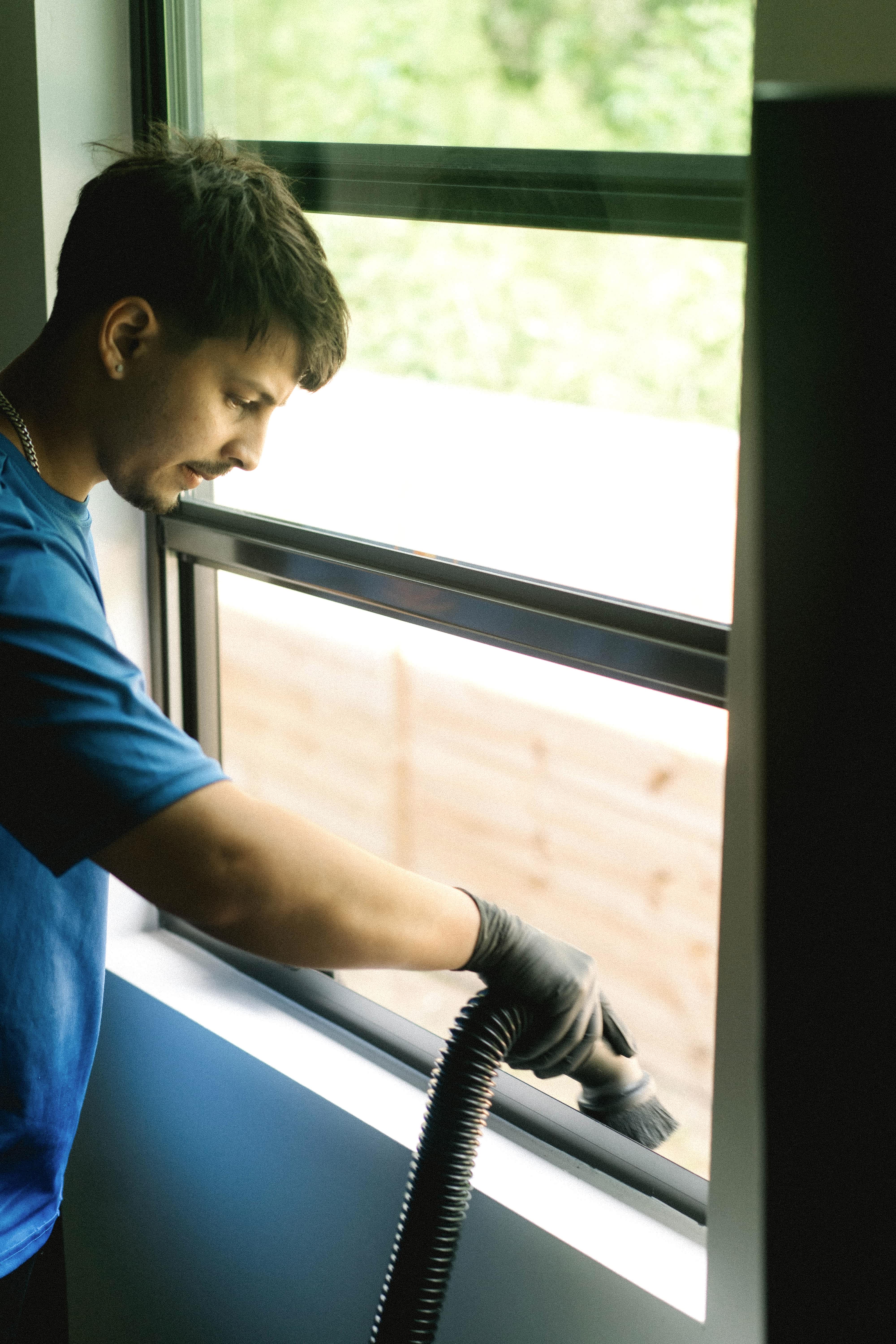 Vacuuming built-up debris from a window track