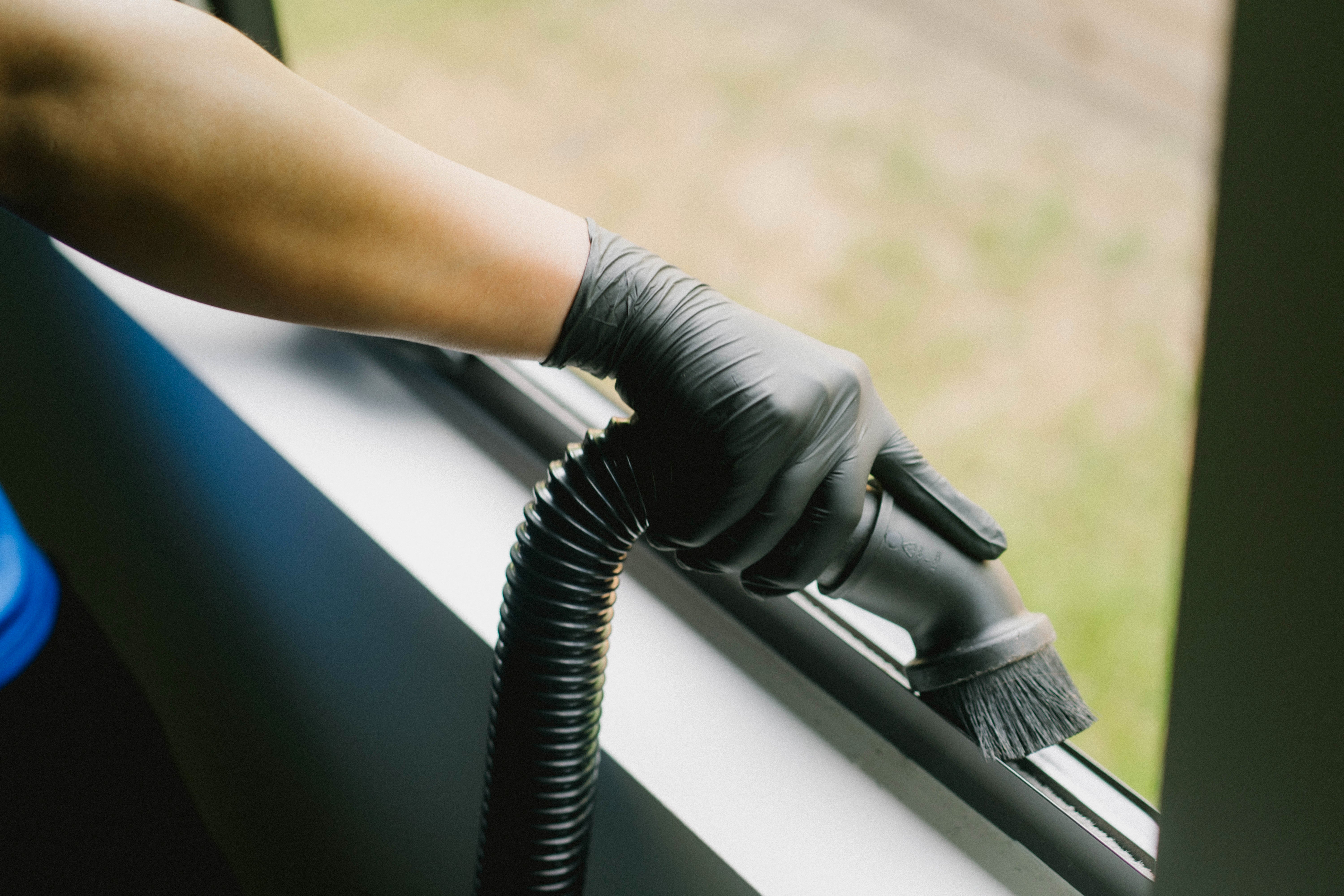 Detailing a window track with a brush and vacuum tool