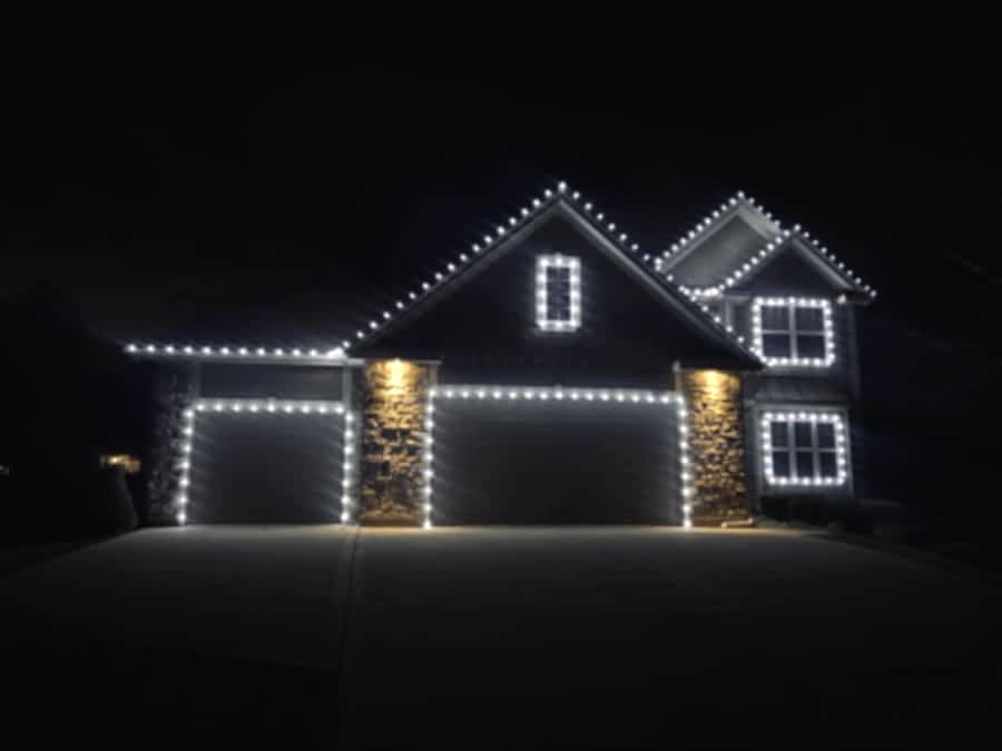 Professionally installed holiday lights on a Houston-area home at night